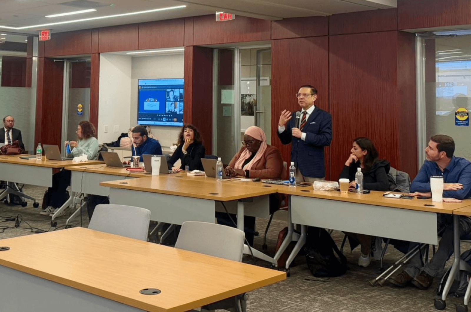 Gerardo Tablas leading a seminar for a seated group in a conference room
